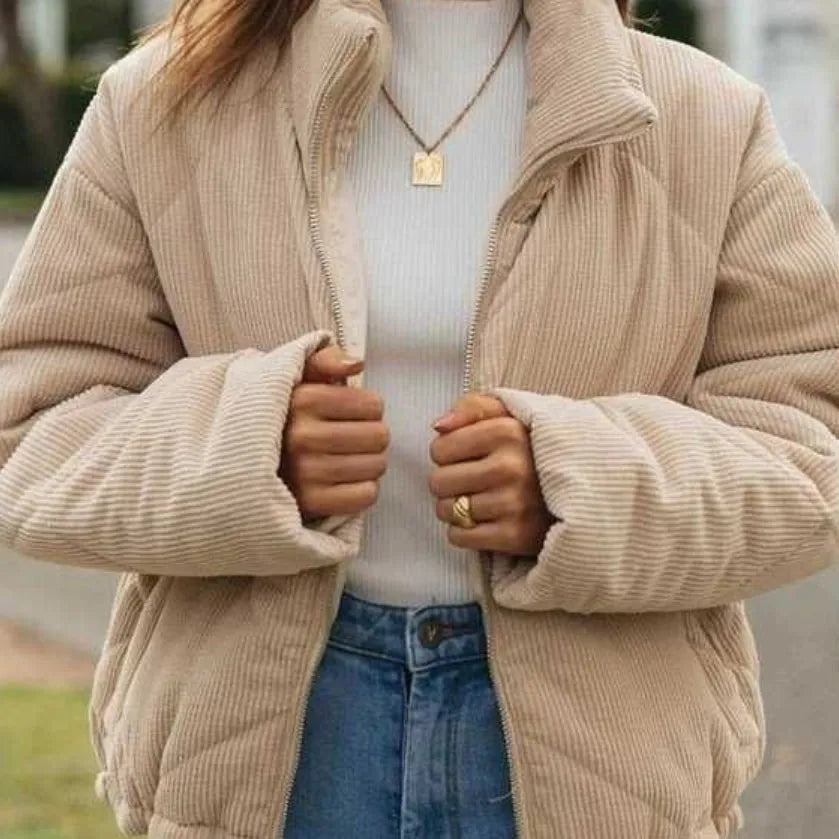 Women's apricot corduroy jacket with stand collar, long sleeves, and zipper closure, showing textured fabric and wadded design.