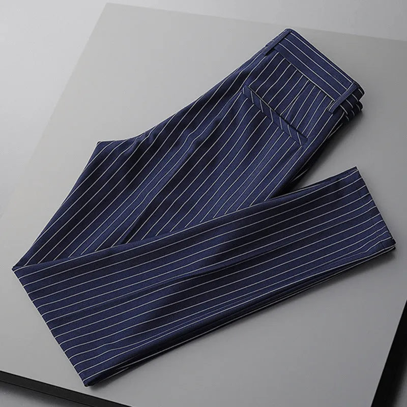 Man wearing loose fit thin striped suit pants in a crop jeans style, available in black or white.