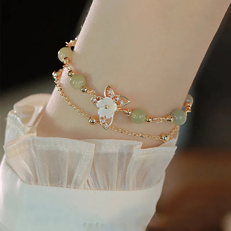 Yellow gold electroplated copper bracelet with butterfly charm and geometric shape for women.
