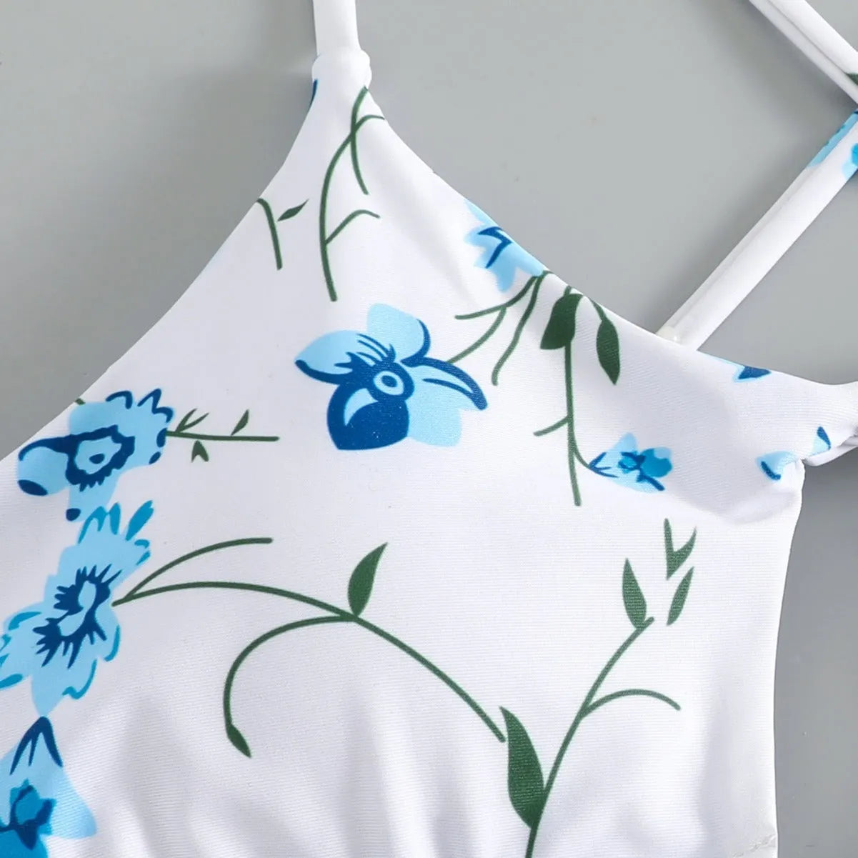 Women's floral patterned tie-neck triangle bikini top with matching shorts swimwear set