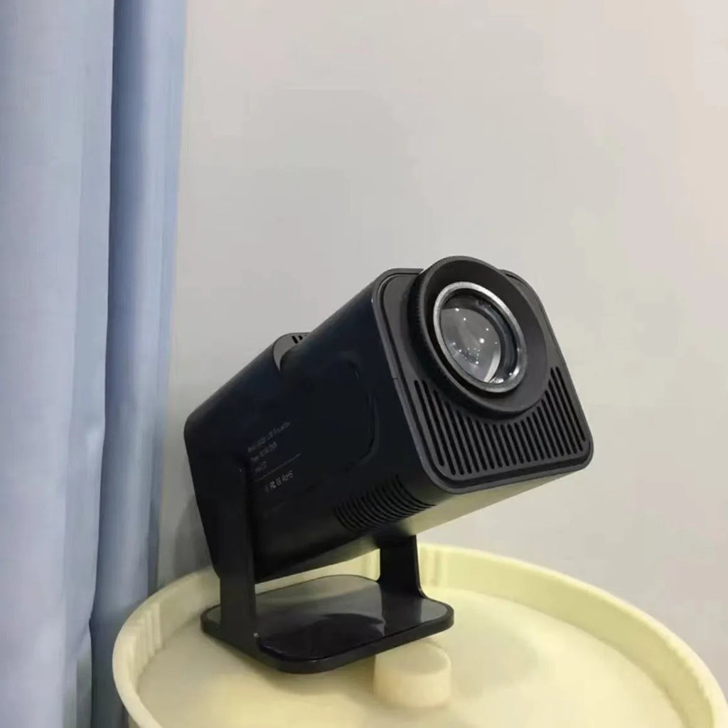 A wireless home gaming projector with a carry handle, showing a 720p HD display on a wall.