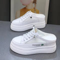 White women's platform shoes with mesh detail and a round toe on a rubber sole.