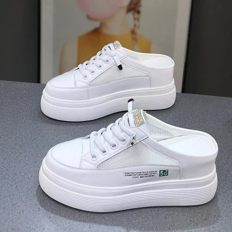 White women's platform shoes with mesh detail and a round toe on a rubber sole.