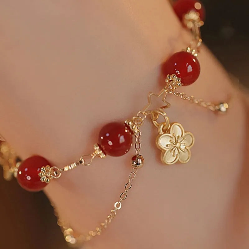 Women's red agate double layer bracelet with floral motifs and adjustable sliding knot closure