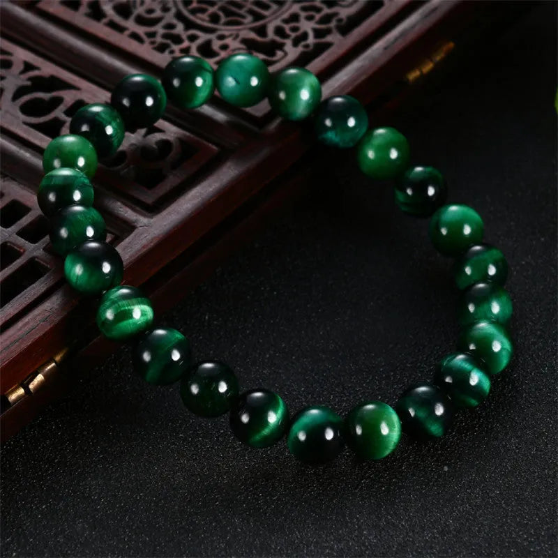 Green tiger eye stone bracelet with geometric beads in hand-polished finish showing natural colour banding