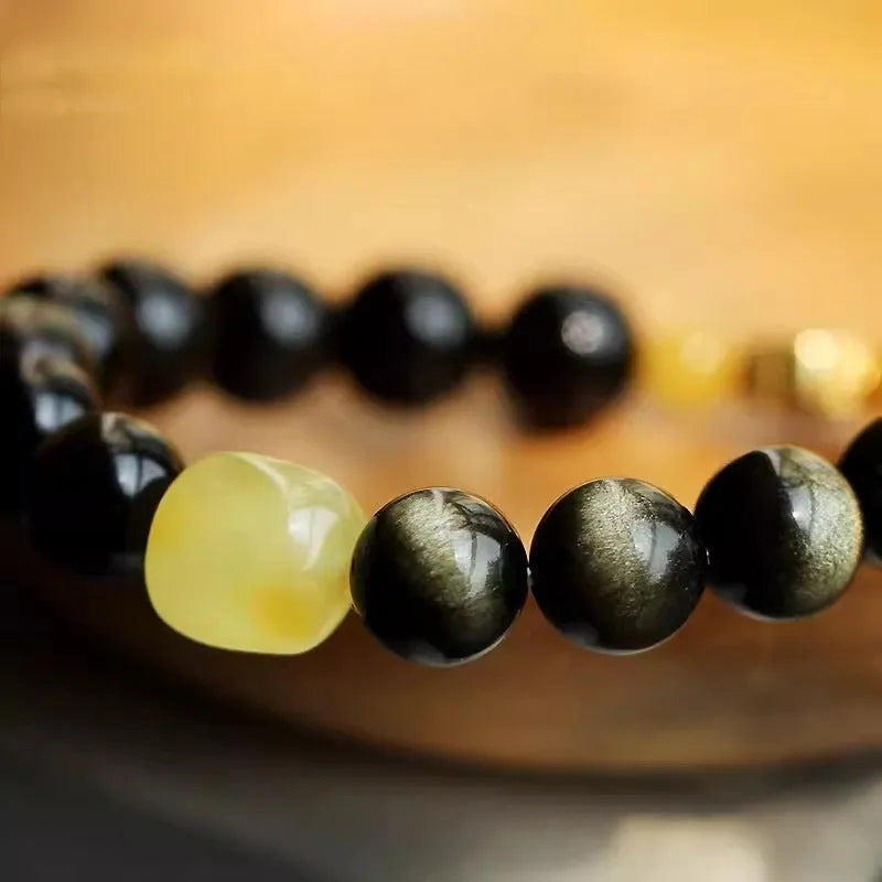 Golden obsidian bracelet with hand-carved Chinese zodiac animal beads in geometric shapes