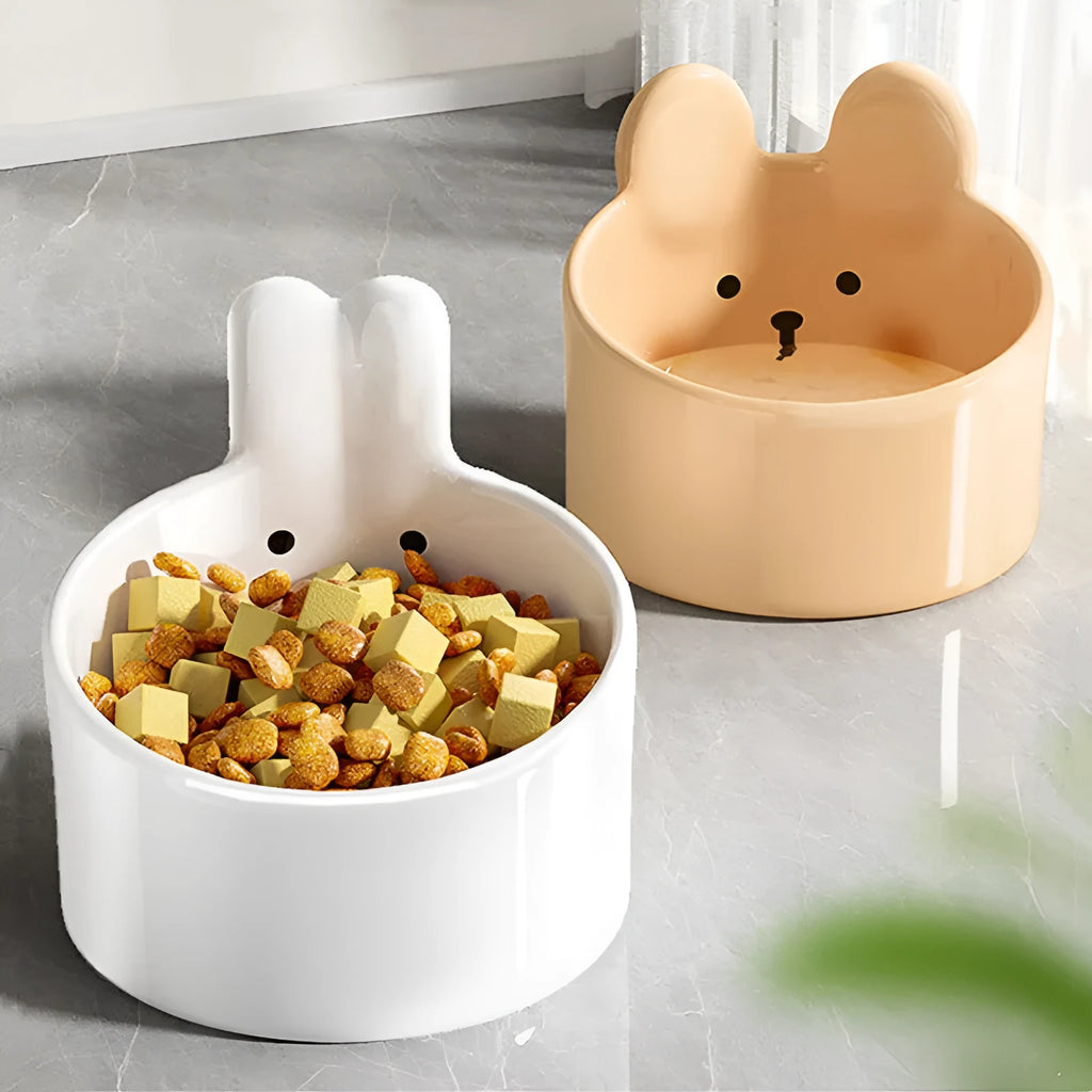 Ceramic pet bowl with neck guard design in white rabbit pattern, shown next to a large brown bear pattern bowl.