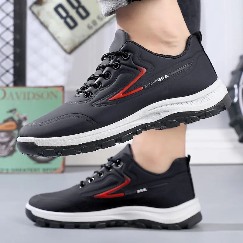 Waterproof casual sports shoes in black-grey colour with flat plastic sole and low-top design