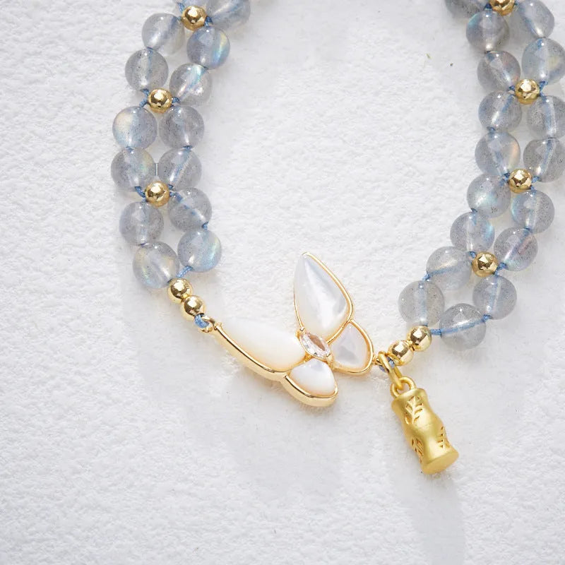 Grey moonstone bracelet with butterfly weave pattern on woven cord