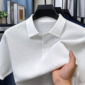 Man wearing a loose navy blue short sleeve cotton pullover sweater casually.