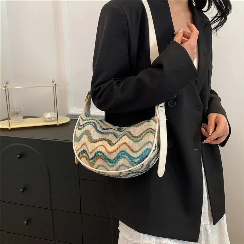 Women's woven straw crossbody bag showing internal phone and file compartments in corrugated brown colour