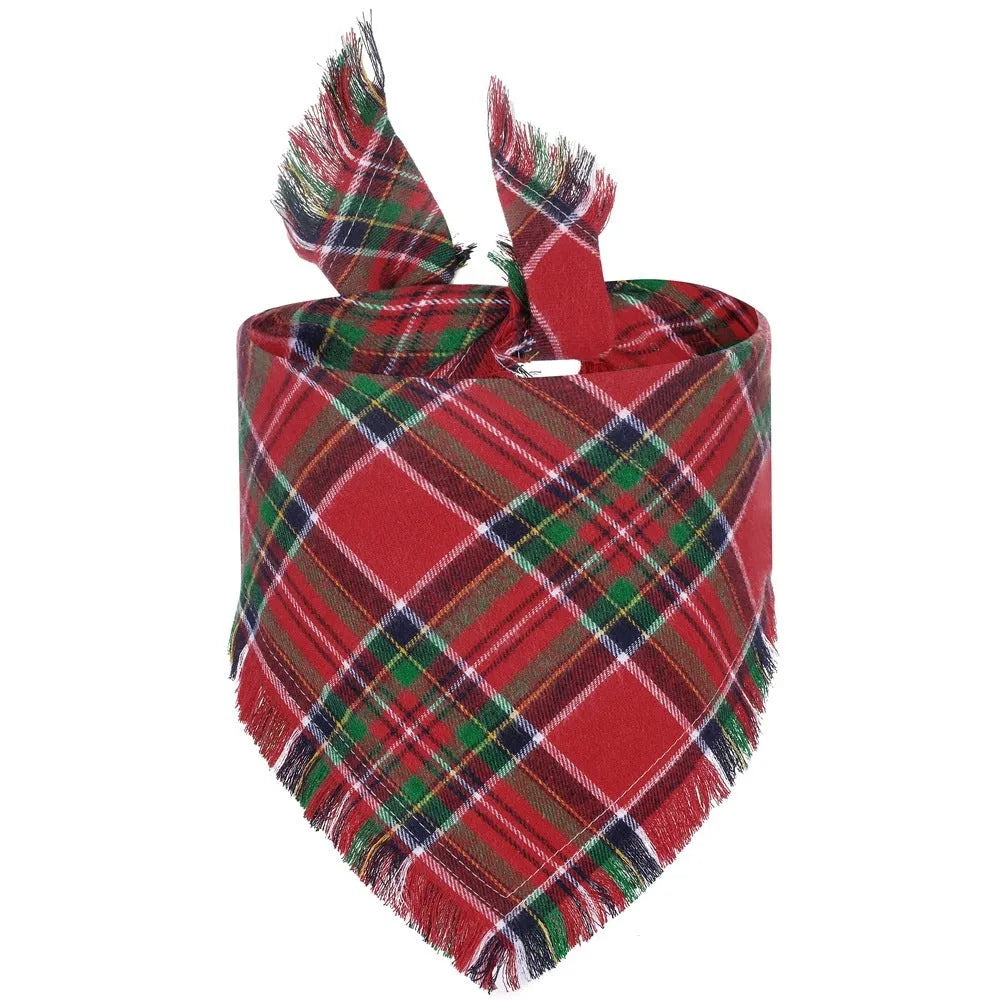 Plaid triangle dog bandana with tassel edges in autumn colours on a dog's neck.