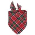 Plaid triangle dog bandana with tassel edges in autumn colours on a dog's neck.