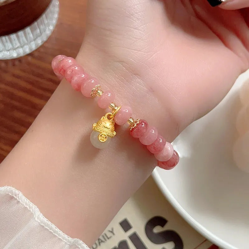 Women's strawberry quartz lucky cat bracelet with animal zodiac charm and retro styling