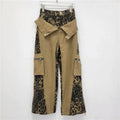 Dark khaki leopard print high waist straight leg jeans with contrast colour stitching on a mannequin.