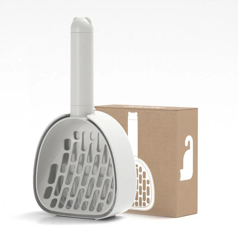 White ABS plastic cat litter scoop standing on a matching storage base with integrated waste bag roll.