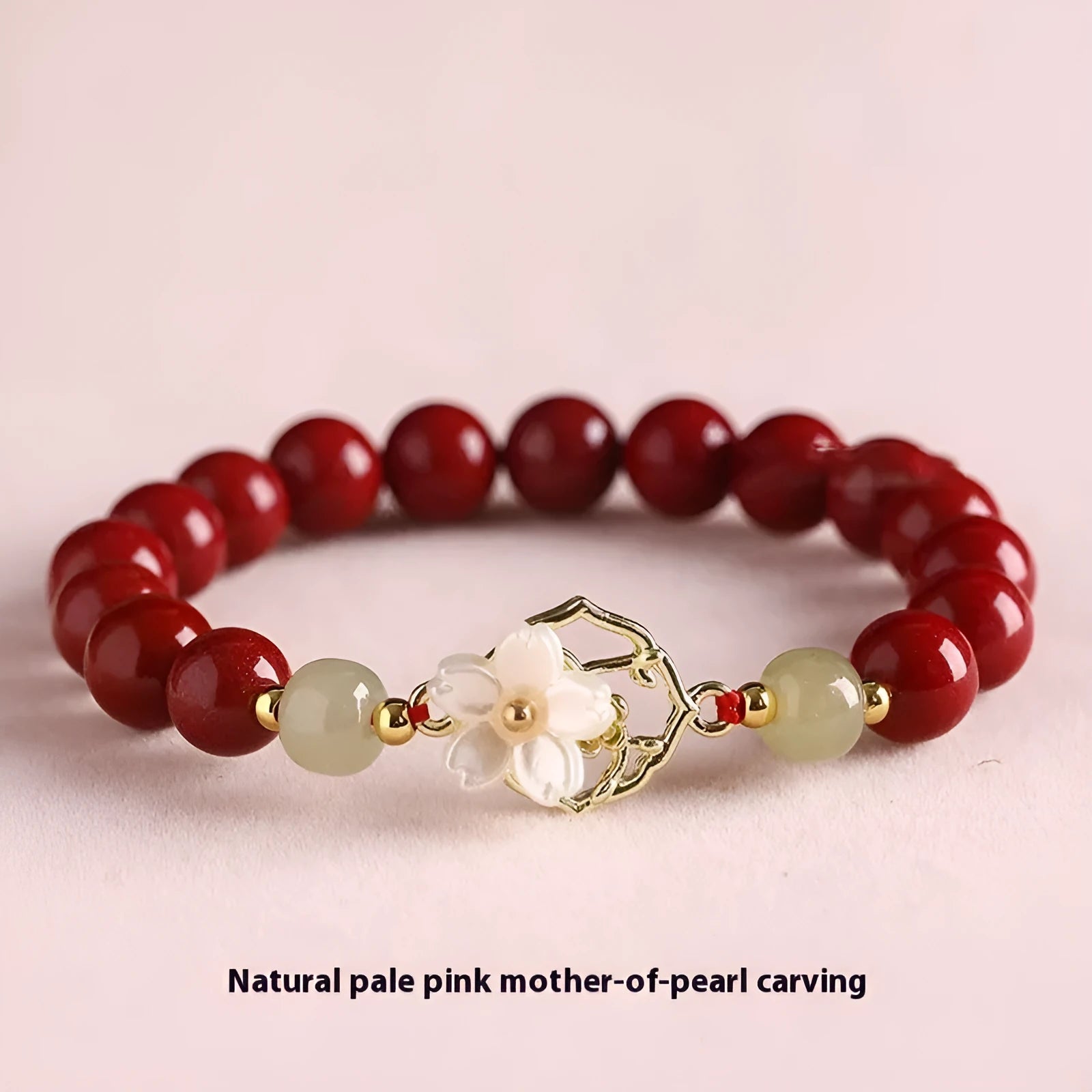 Handcrafted cinnabar bracelet with white Hetian jade butterfly charm, Bells of Ireland, and lotus details in New Chinese style.
