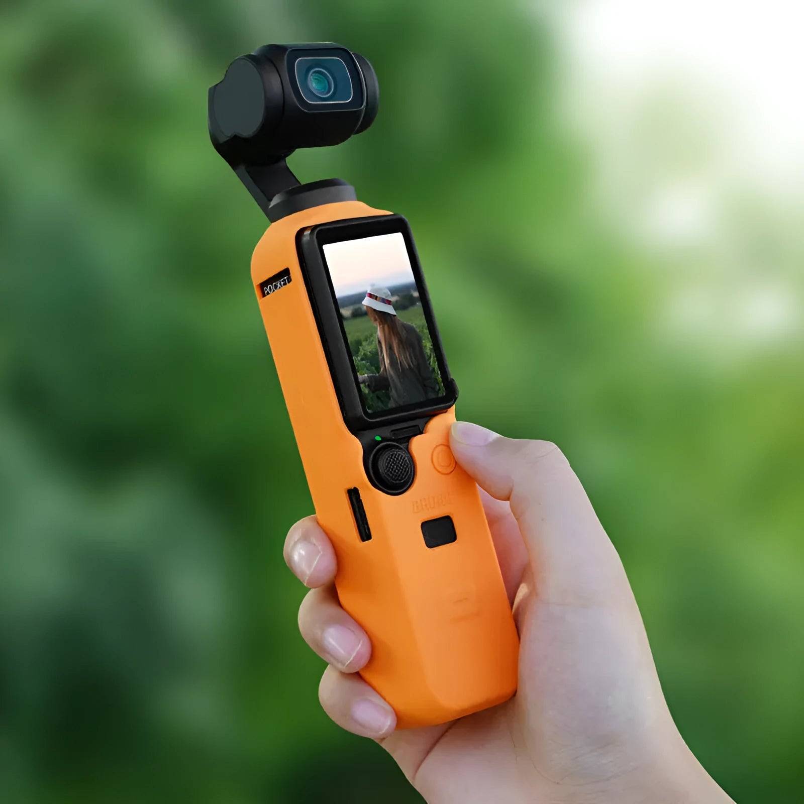 Black silicone protective sleeve for a PTZ camera body, shown alongside red and orange versions.