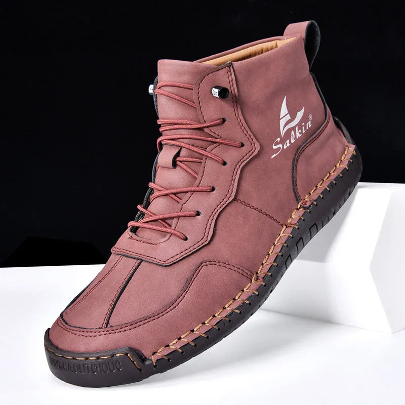 A pair of beige retro high-top casual leather boots with a round toe and elastic band fastening on a plain background.
