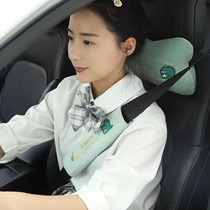 Plush embroidered car headrest shoulder pad in blue, green, black or pink with cartoon lion, dinosaur, kitten, puppy or rabbit motif
