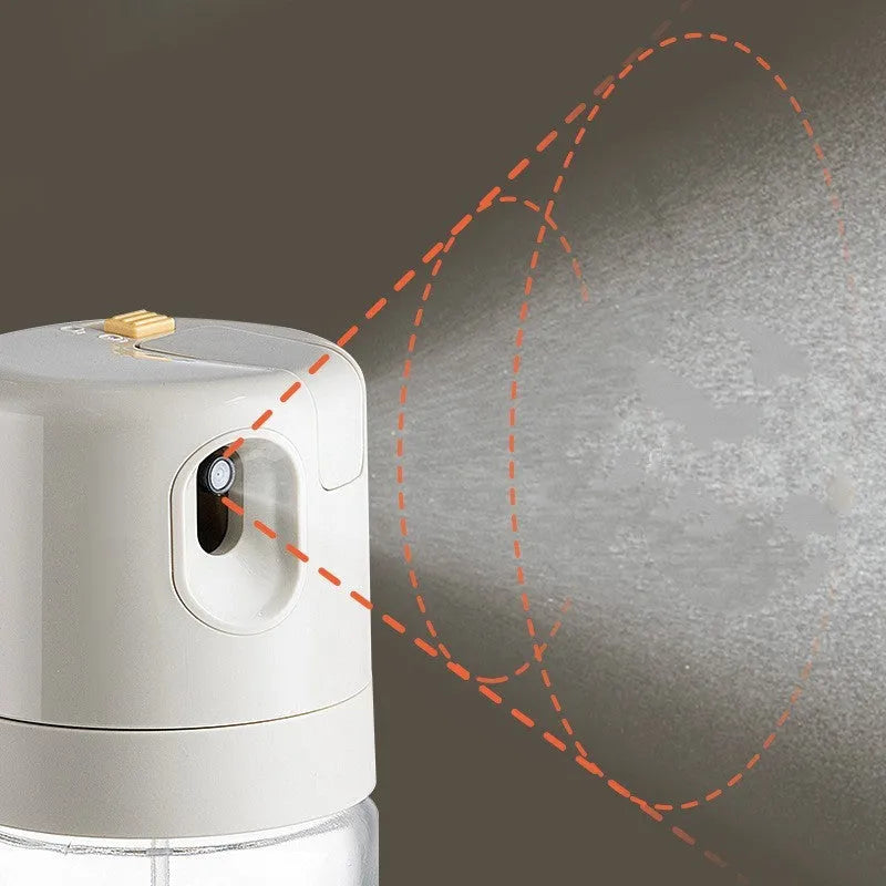 Warm grey glass 2-in-1 oil sprayer and pourer bottle with switchable cap on kitchen counter