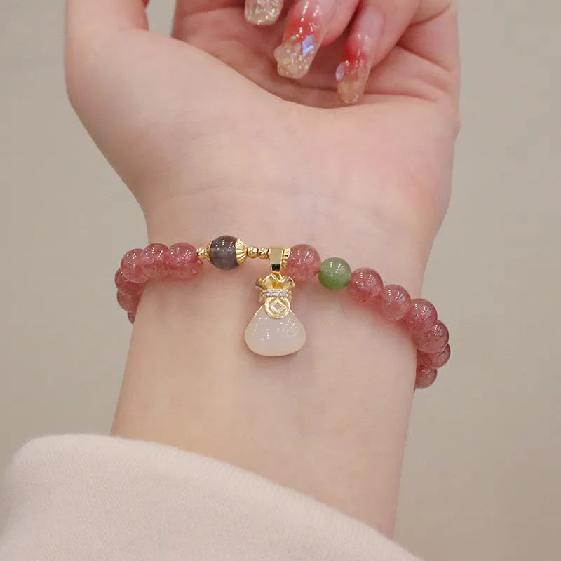 Women's strawberry quartz bracelet with geometric design, purse charm, and safety buckle closure