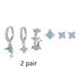 Flower-shaped ear studs with zircon mosaic in gold or silver finish, showing geometric design details