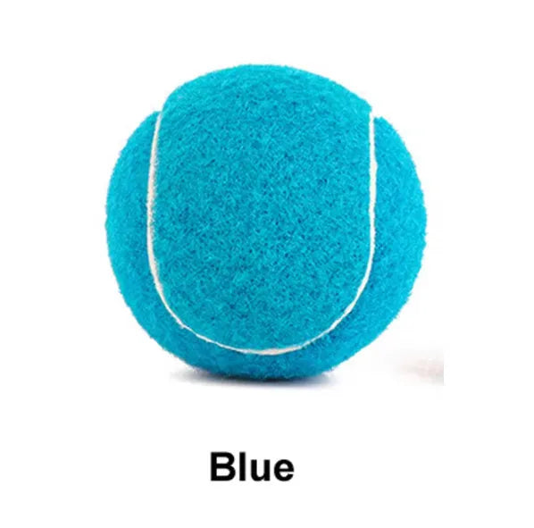 A 6.3cm pink rubber dog tennis ball sitting on grass.