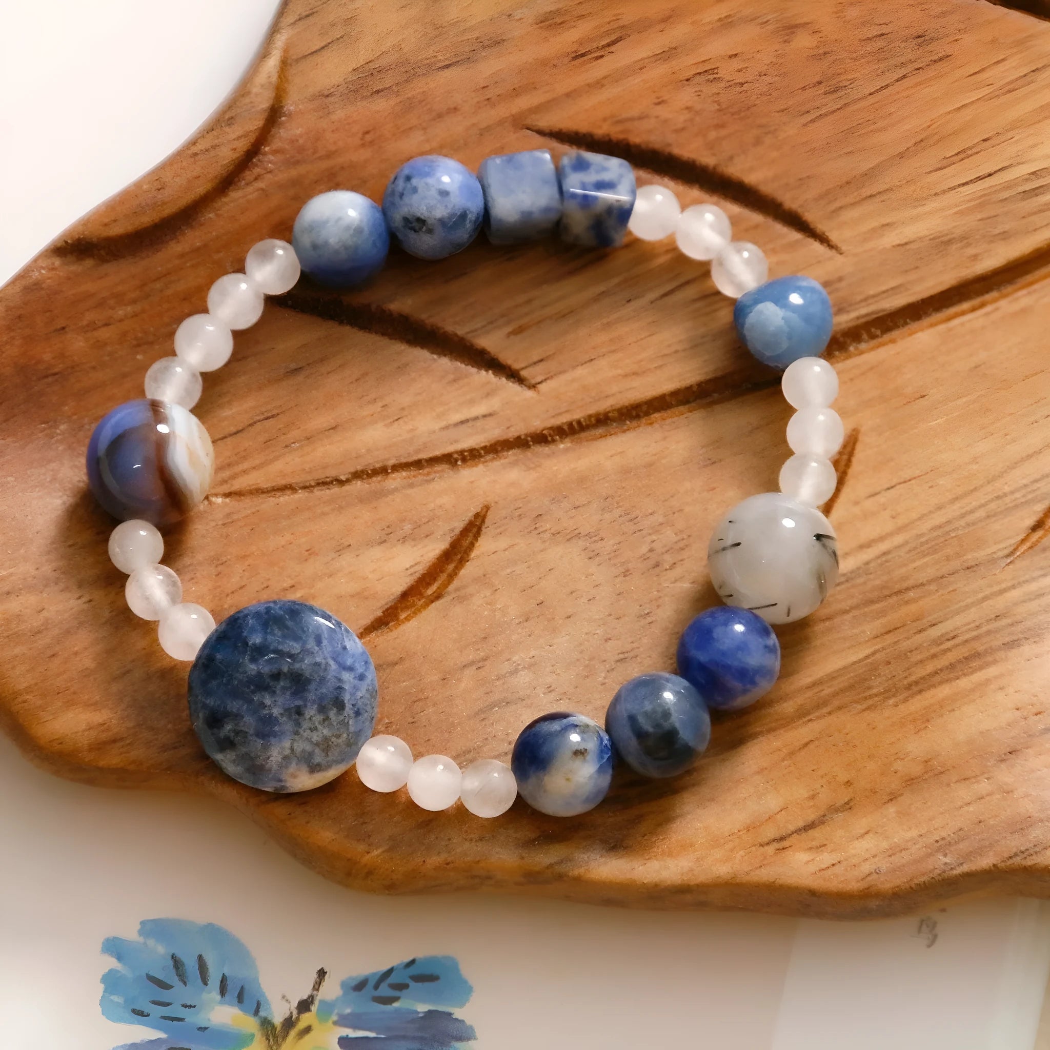 Hand-woven natural stone bracelet with blue point stone and black hair crystal agate in geometric design