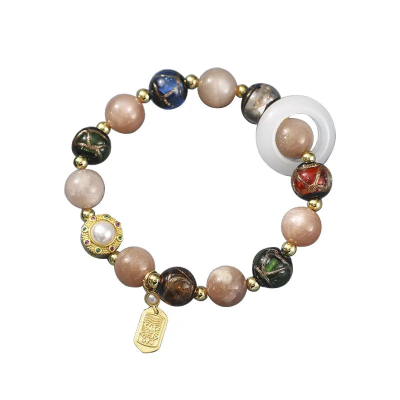 Hand-woven fragrant grey coloured glaze bracelet with round sunstone or white lip shell beads.