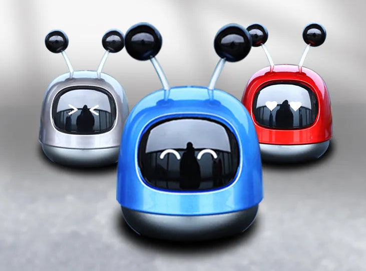 Blue robot car decorative ornament clipped to a car air vent as an aromatherapy diffuser.