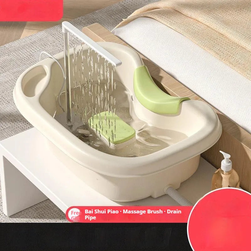 Portable bed shampoo basin with integrated neck pillow, circulating water pump, drain pipe, and massage brush for hair washing while lying down