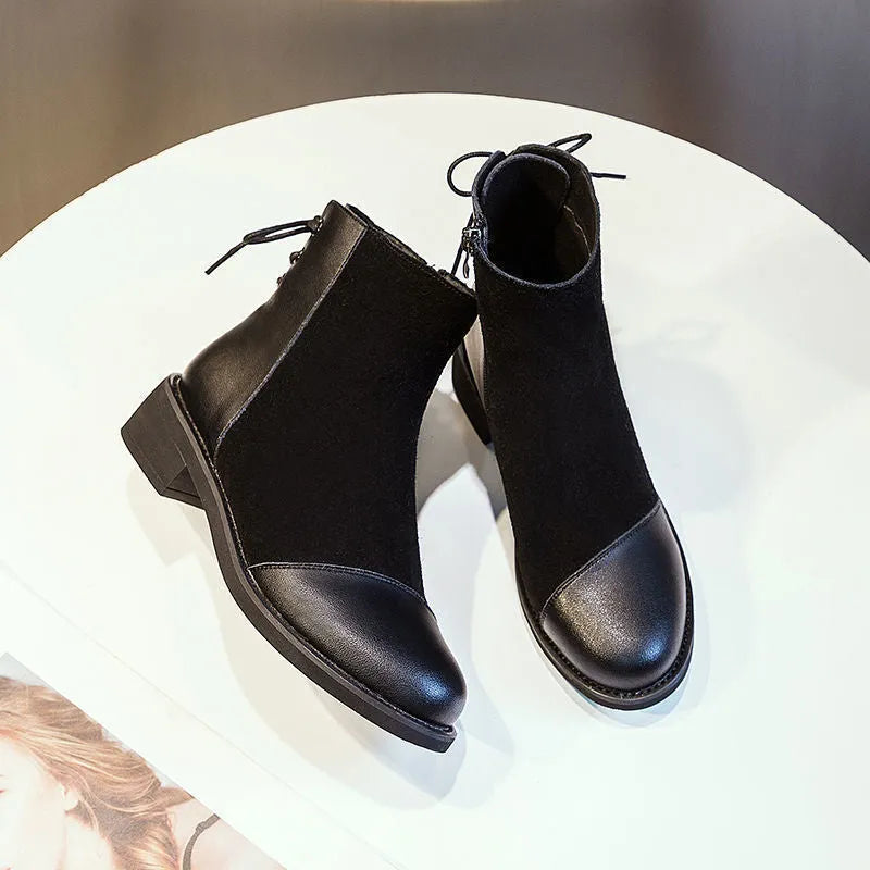 Black women's Martin boots with non-slip rubber soles and side zipper, showing round toe and short stout heel.