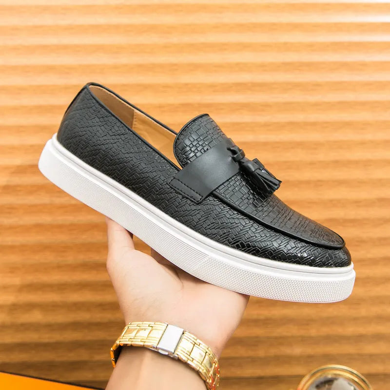 Men's black casual leather shoes with fringe detail on the upper and a low heel.