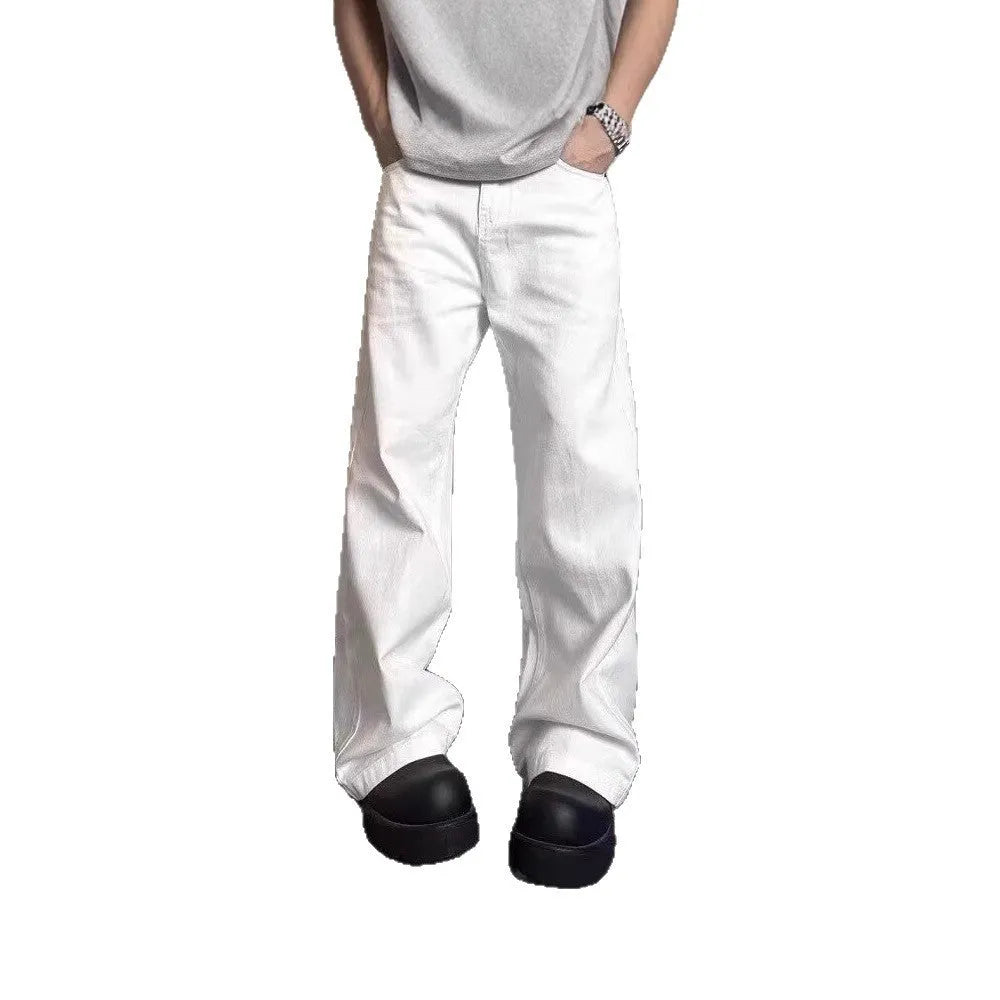 Men's straight-leg white denim jeans with mid-waist and zipper fly, shown in a summer setting.