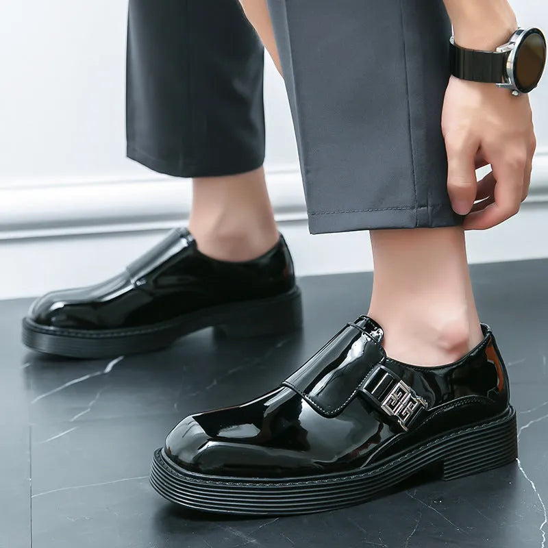 Men's black glossy PU leather loafers with a low platform sole, shown in a summer setting.