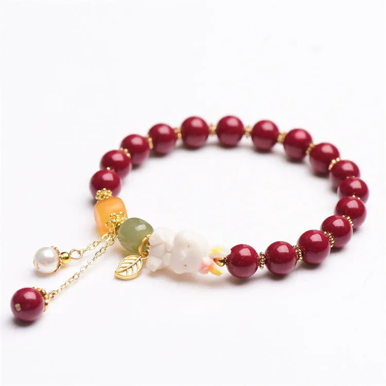 Natural Tian Yu cinnabar bracelet in purple gold sand colour with rabbit design, shown in 8mm and 10mm width options