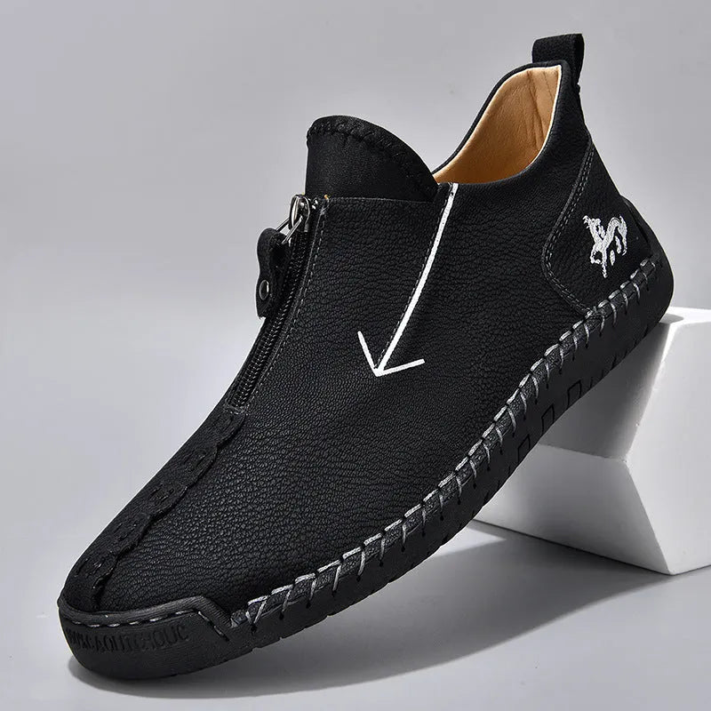 Men's black leather boots with front zipper, hand-stitched sole, and mid-calf length