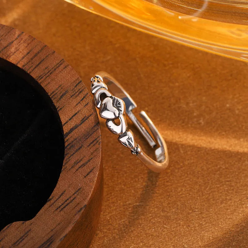 Retro silver coloured open band heart ring made of copper for women.
