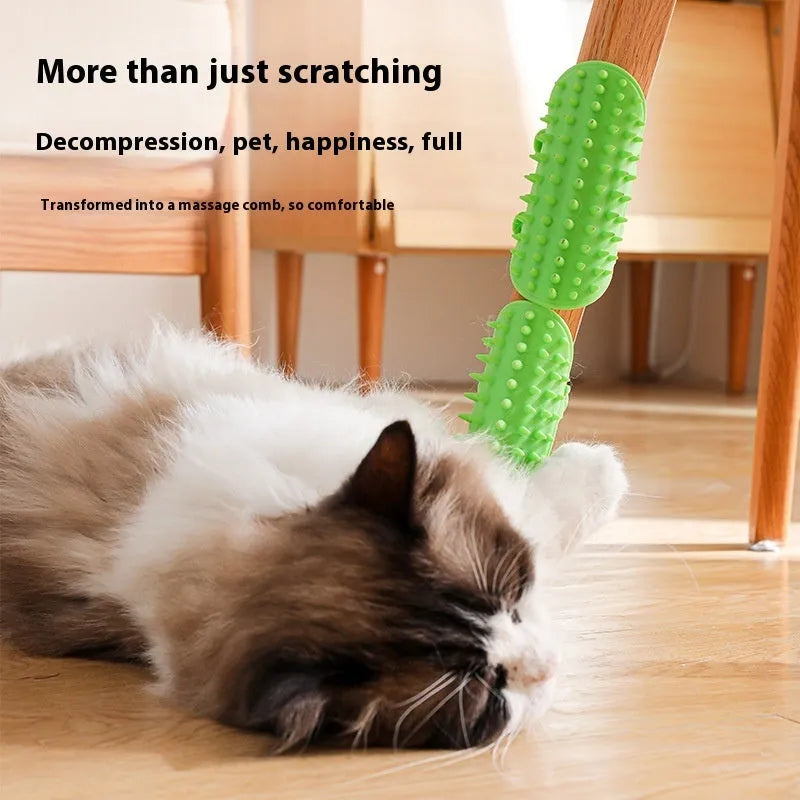 Black silicone cat grooming comb with adjustable strap attached to a table leg, showing rounded teeth for hair removal