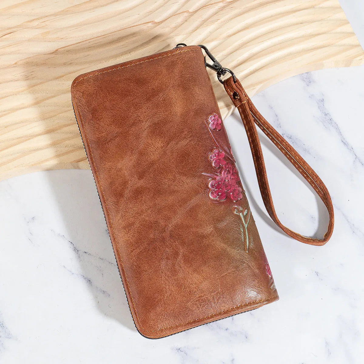 Embossed and hand-painted floral pattern on a brown Chinese-style zipper handbag.