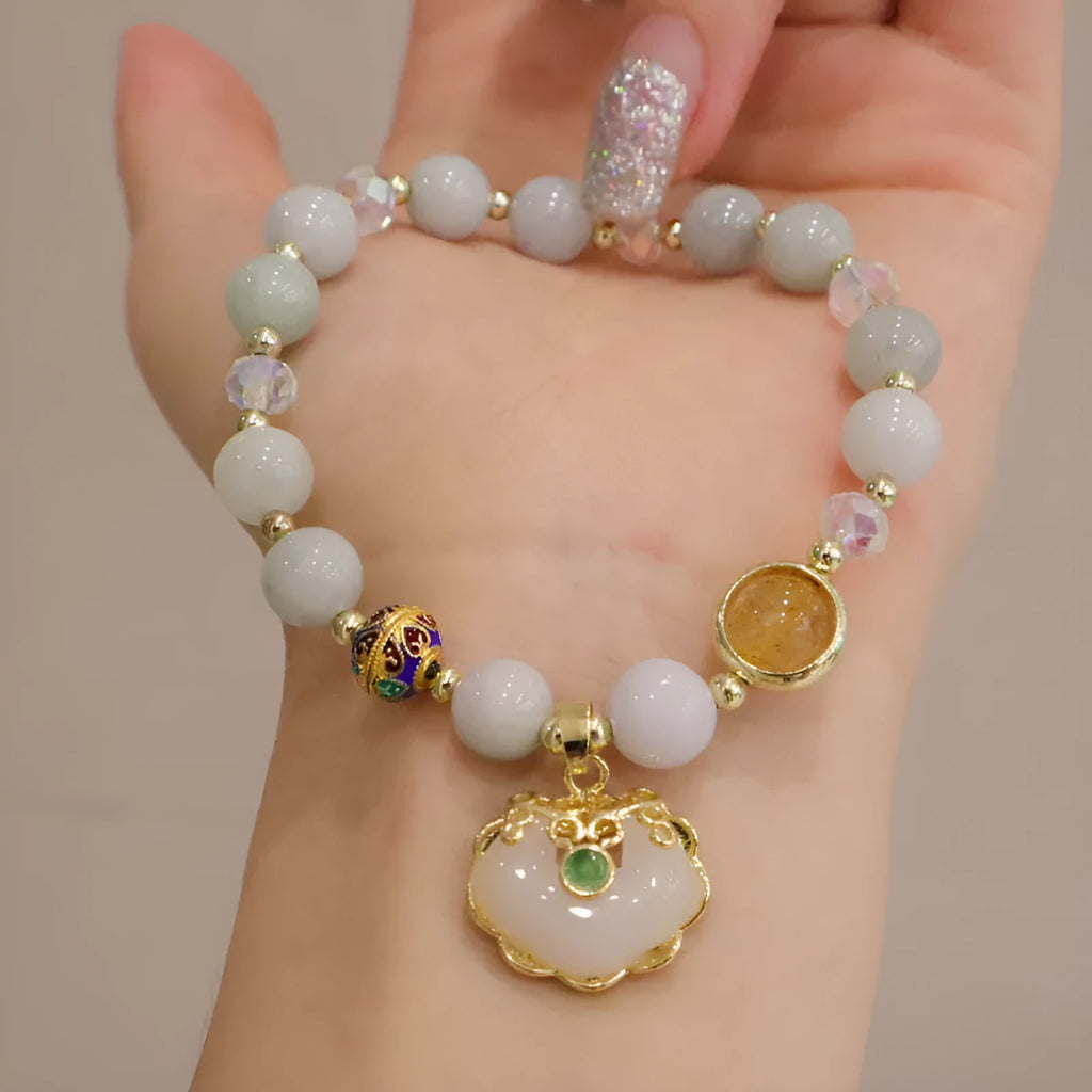 Women's ethnic bracelet with grey jade beads, strawberry quartz stones and geometric metal decorations