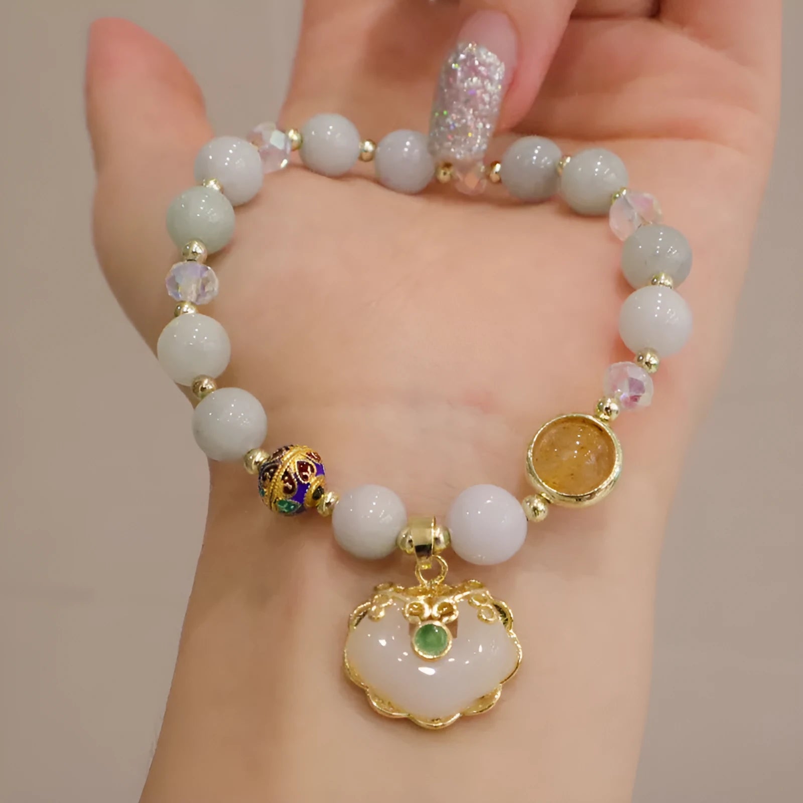 Women's ethnic bracelet with grey jade beads, strawberry quartz stones and geometric metal decorations