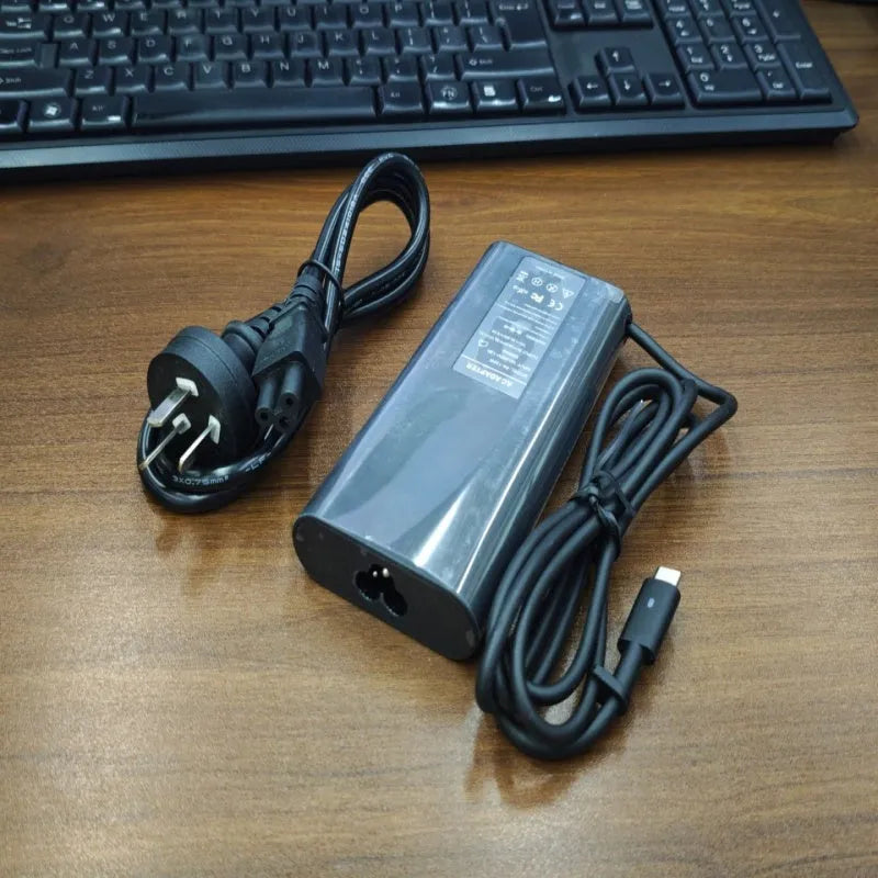 Black 65W USB Type-C laptop power adapter with international travel plug set
