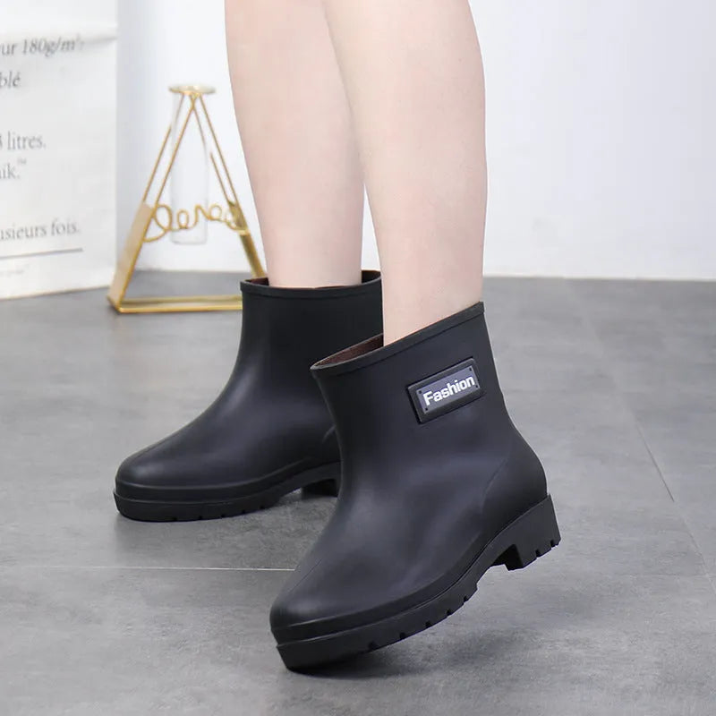 Women's PVC mid-calf rain boots in black, brown, apricot, and purple colours
