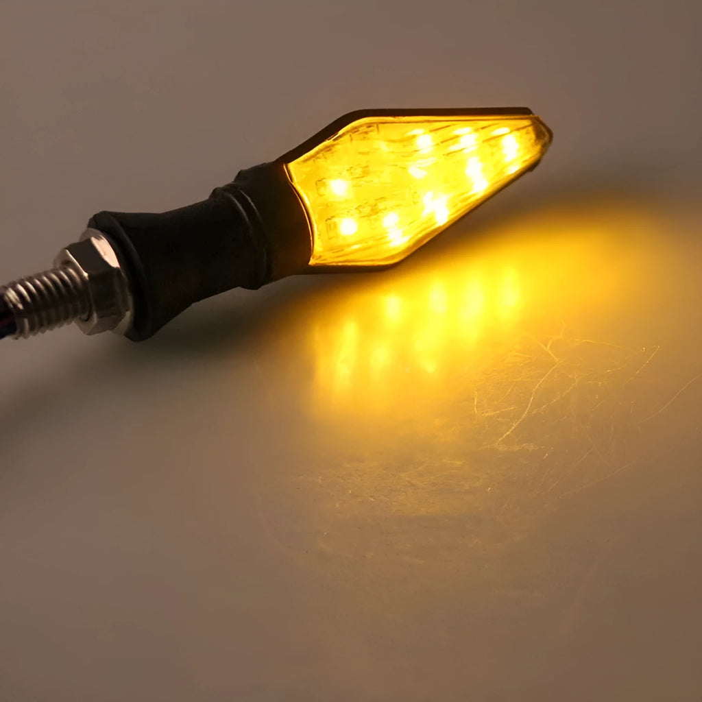 Motorcycle turn signal lights with plastic LED construction showing yellow and blue illumination