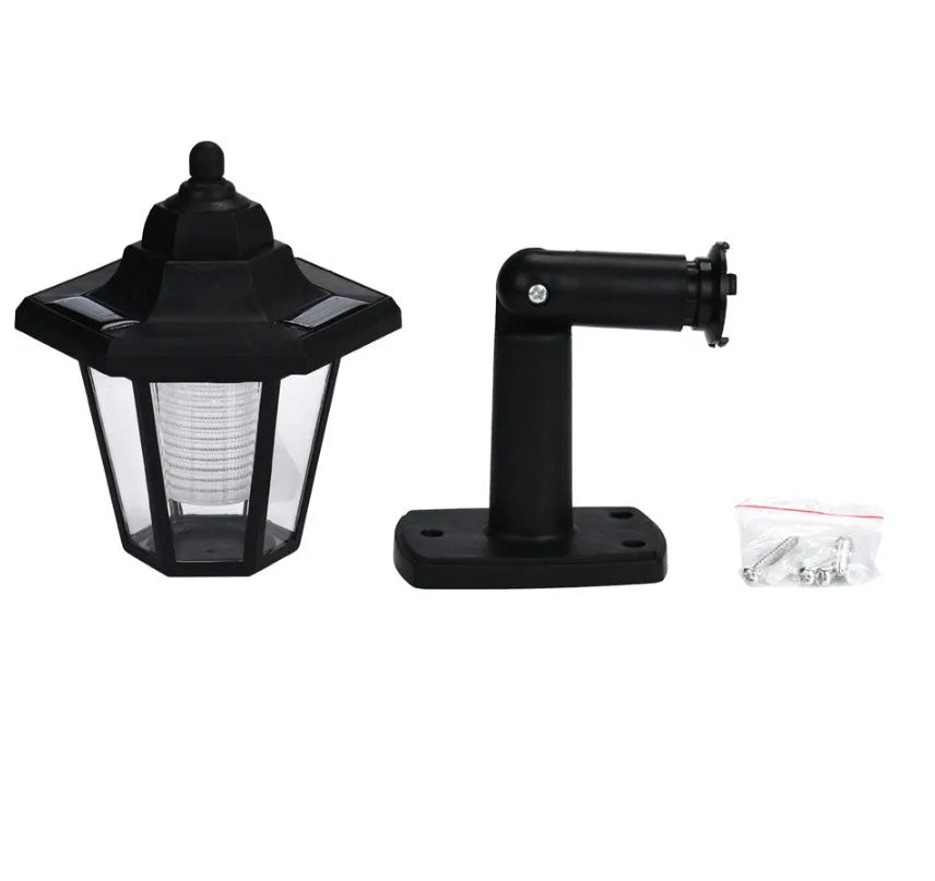 Black hexagonal solar-powered LED wall light for outdoor garden use.