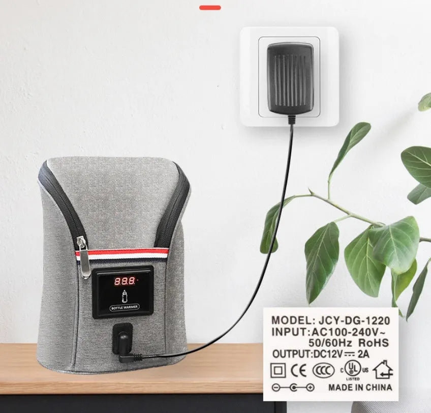 Grey portable baby bottle warmer with electronic display, car charger, and buckle for hanging on prams