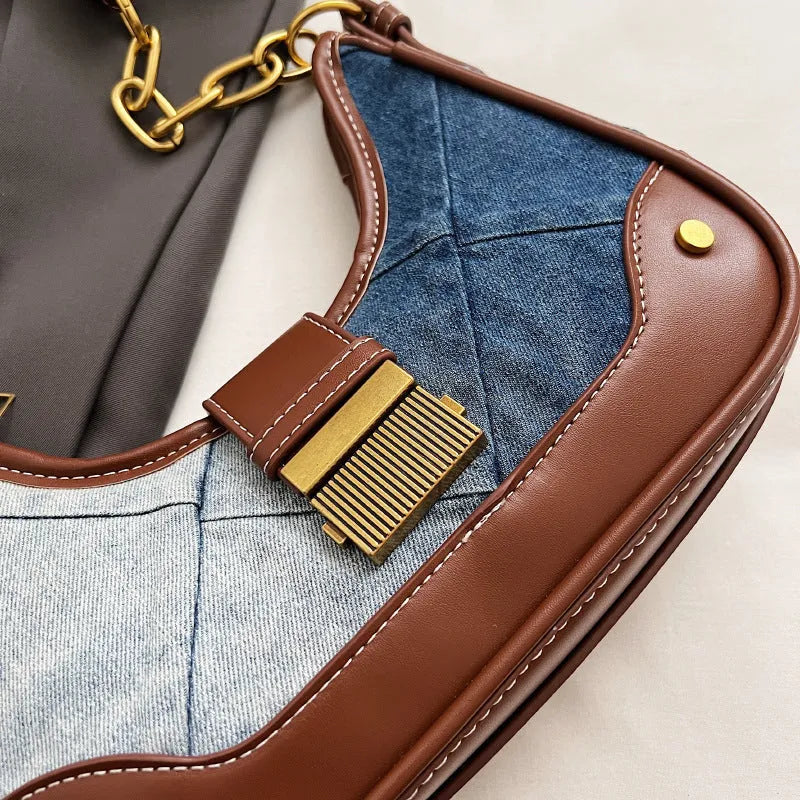 Brown denim women's bucket shoulder bag with diamond mesh detail, chain accents, and double adjustable straps
