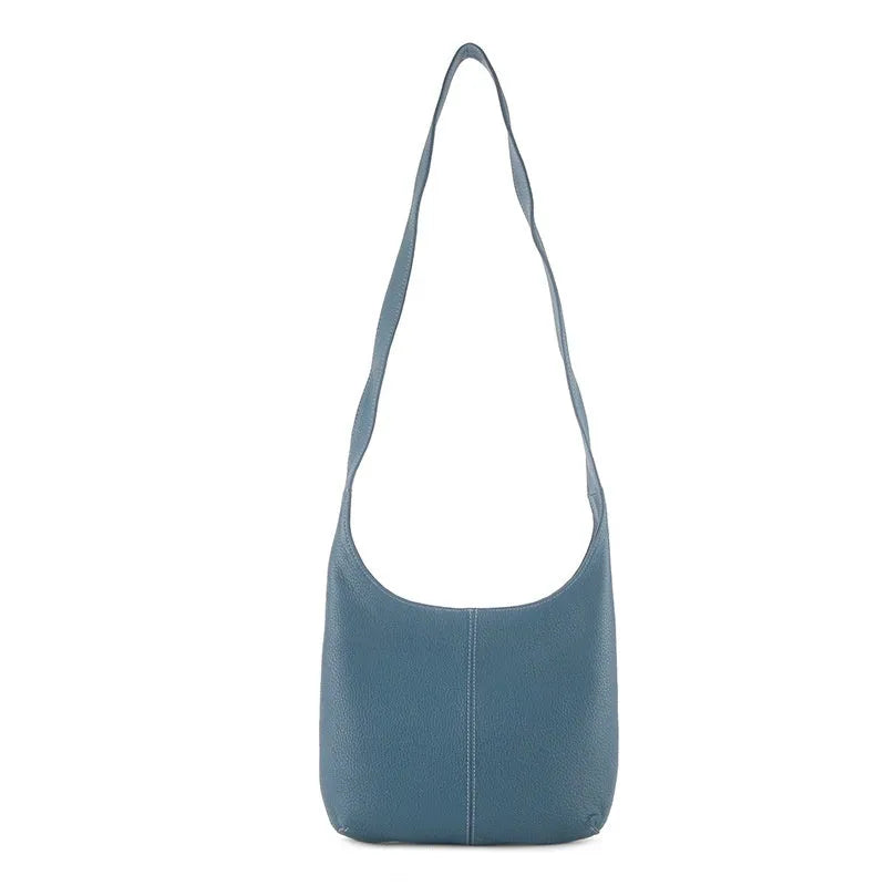 Leather women's casual zip crossbody bag in top grain genuine leather with canvas lining and open outer pocket.